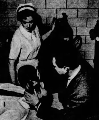 Registered Nurse Miss Helen Parrish assisting the attending psychiatrist with a CO-2 treatment on a patient.